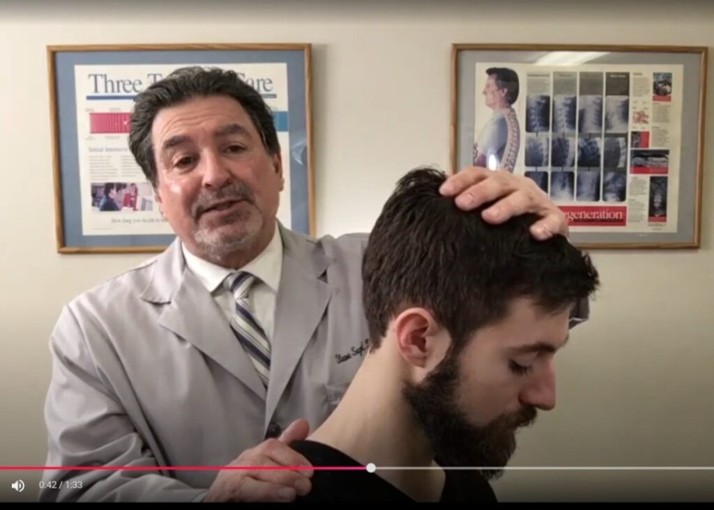 Dr. Steve Segal, chiropractor in Libertyville, performing a neck exam